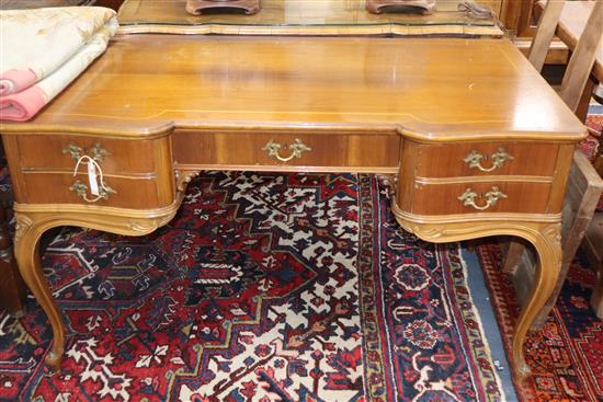 A Louis XV style walnut five drawer writing table, on slender cabriole legs W.130cm